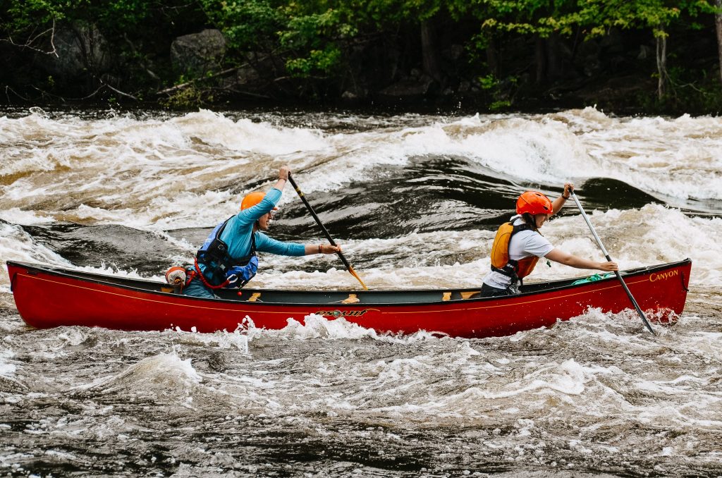 Two people canoe in rapids on the Madawaska River