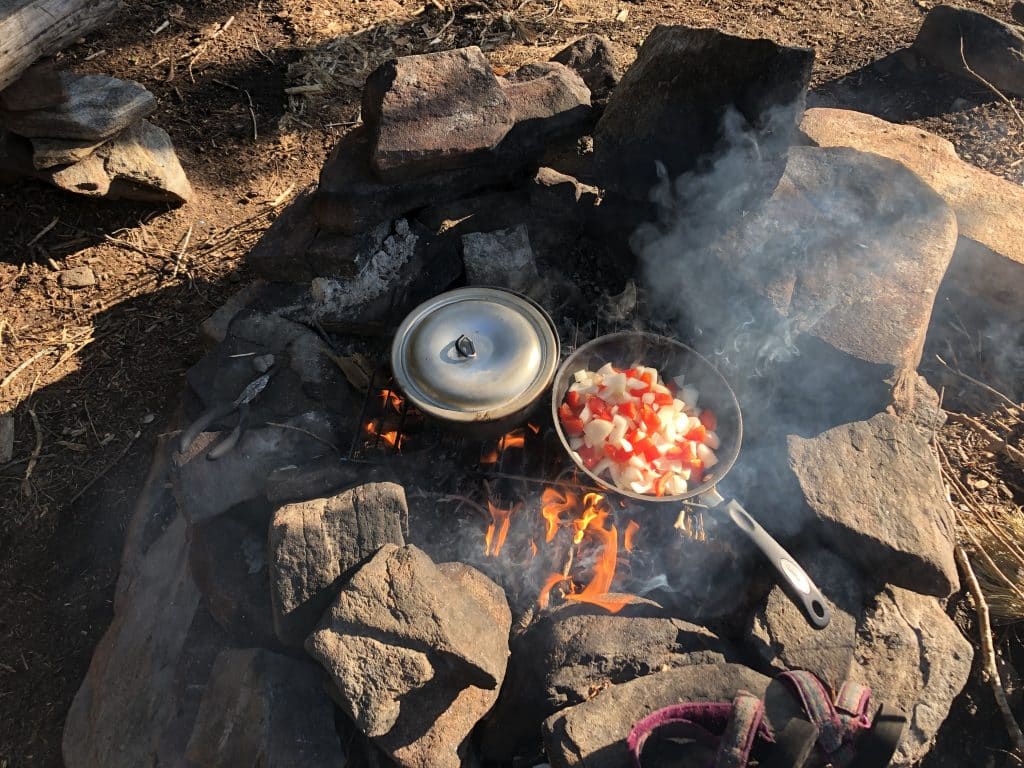 Cooking in a cast iron camp oven