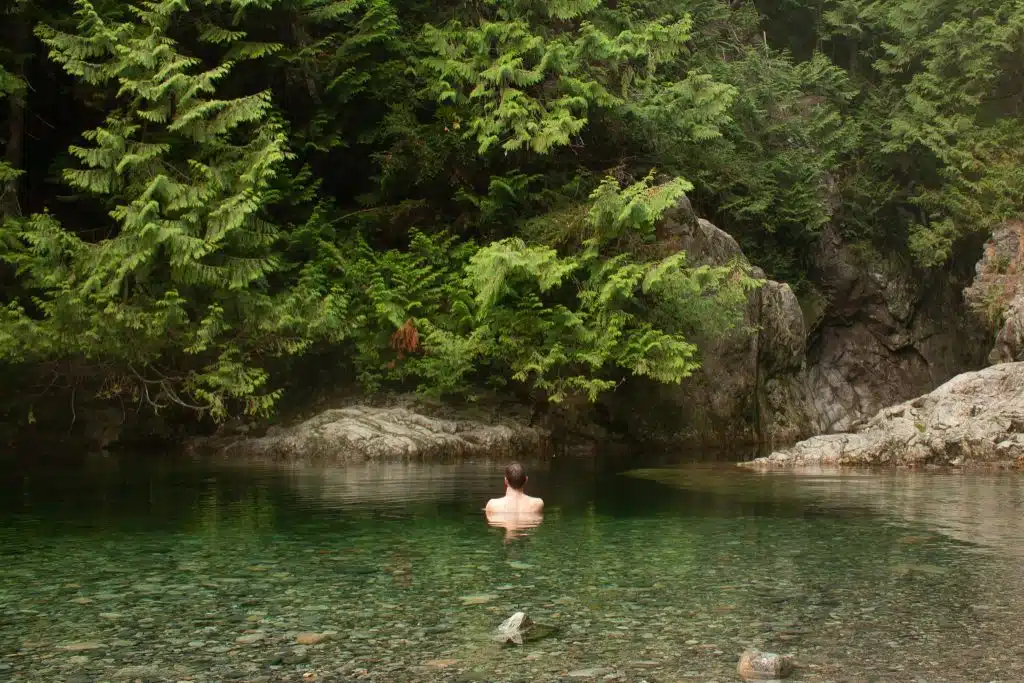 Guy swimming in water near 30 ft pool in Lynn Canyon