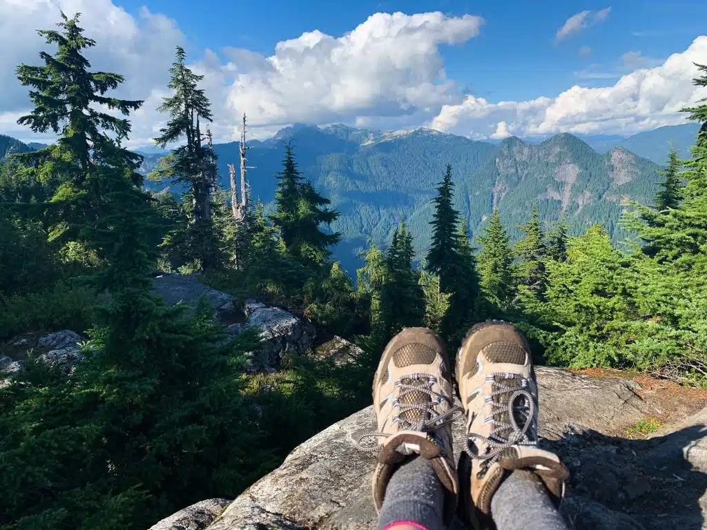View of mountains from the top of Mount Fromme hiking trail in Vancouver. Hiking boots and wool socks are important things to bring on a hike!