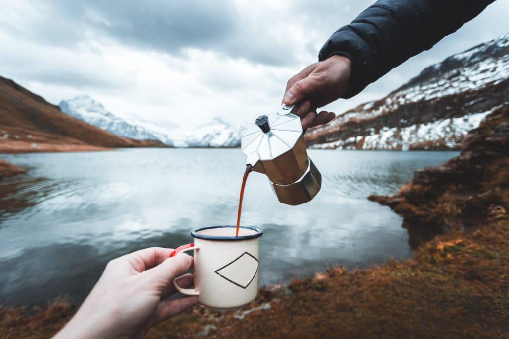 Hike, camping concept. Thermos and aluminum mug hot drink with