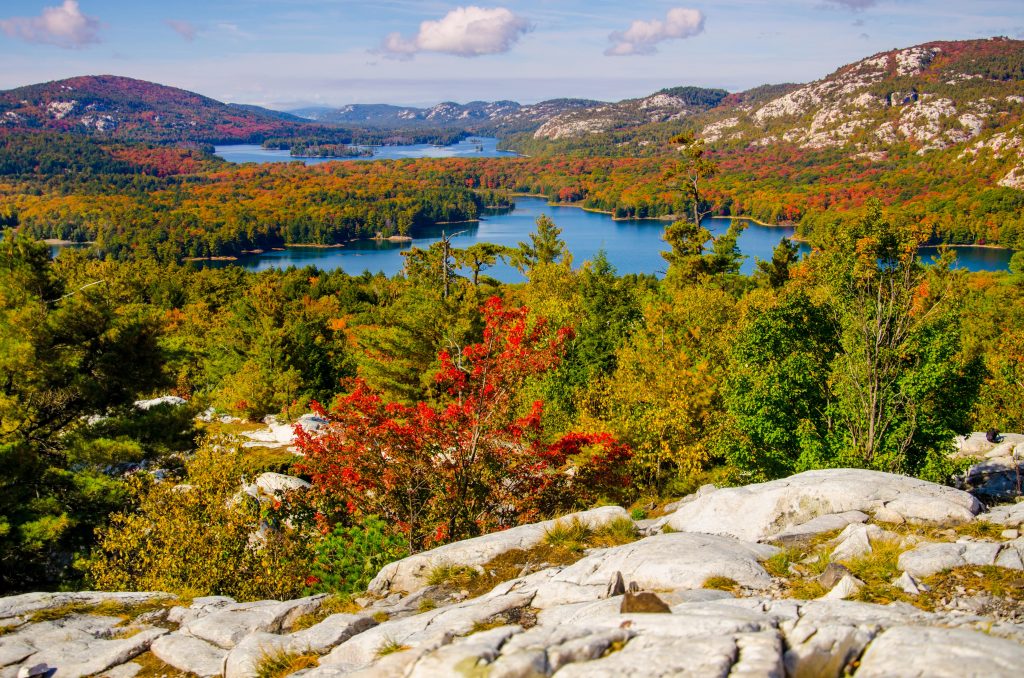 View of blue lake, white La Cloche Mountains and autumn leaves in Killarney Provincial Park