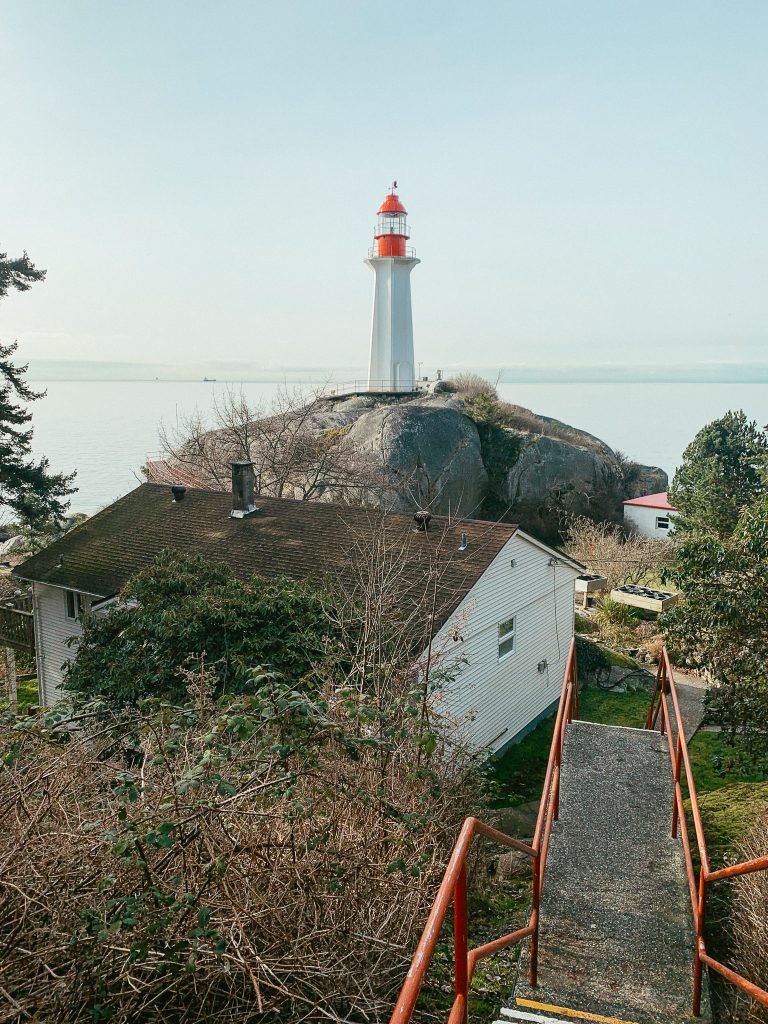 View of a lighthouse and ocean from Lighthouse Park, one of the easiest hikes in Vancouver
